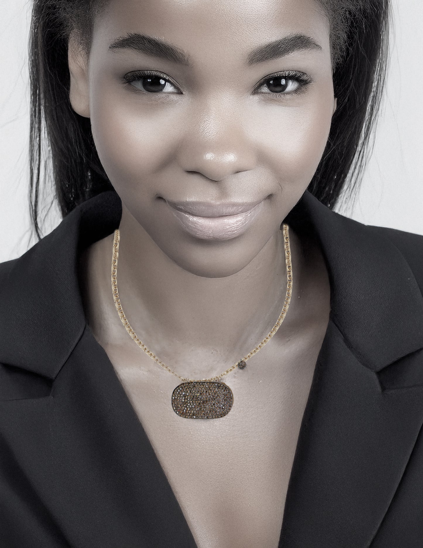 woman wearing a supreme woman necklace with mixed metal gold and pave diamonds on a white background.